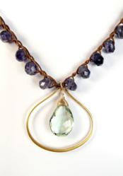 Rock the Casbah in this SKM artworks necklace. Green amethyst and 24k gold vermeil pendant float among iolite stones woven on Irish waxed linen.